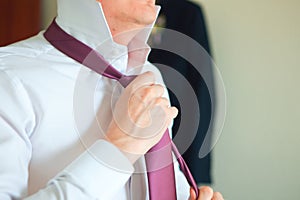 Businessman adjusting his necktie concept for anxiety, worried, meeting or ready for business