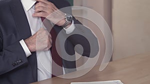 Businessman adjusting his tie.