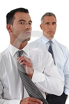 Businessman adjusting tie