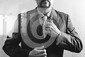 Businessman adjusting tie,Front view, no head. Concept of working in an office.