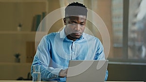 Businessman african american man working on computer in home office make pause drinking glass of cold fresh water health
