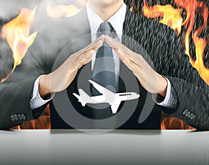 Businessman and airplane with fire background