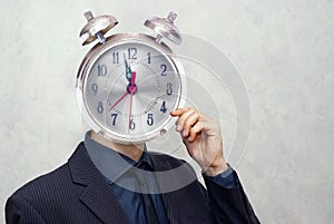 Businessman with alarm clock head