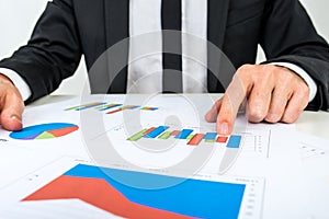 Businessman analysing a set of bar graphs