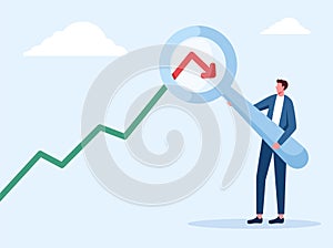 businessman analyst with magnifier on arrow turn down, Down turn or economic recession concept photo