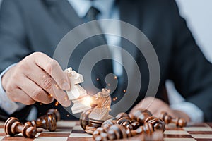 Businessman Analyze chess piece on chess board game concept for ideas and competition