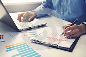 Businessman analyzing annual business report photo