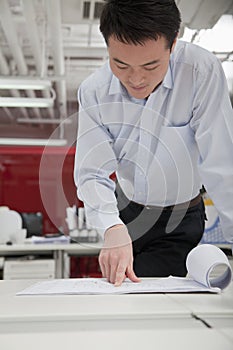 Businessman analyzing architect project in the office