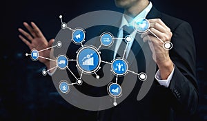 Businessman Analyzing Digital Connectivity with Data Visualization and Technology Icons Representing Growth
