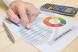 Businessman analyzing financial report on table. Accounting