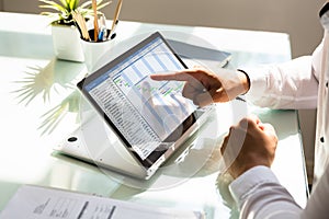 Businessman analyzing gantt chart on laptop