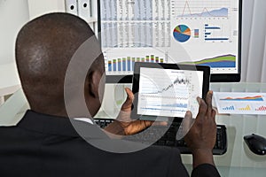Businessman Analyzing Graph On Digital Tablet