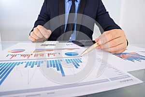 Businessman analyzing graph papers