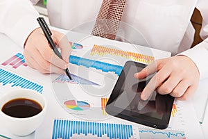 Businessman analyzing graphs and charts