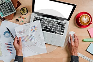 Businessman analyzing investment charts with laptop