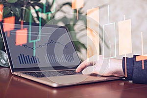 Businessman analyzing investment charts with laptop. Business and finance concept.