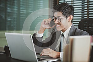 Businessman analyzing investment charts with Smartphones and laptop