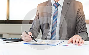 Businessman analyzing report, business performance concept