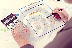 Businessman analyzing report, business performance concept