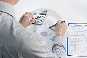 Businessman analyzing report, business performance concept