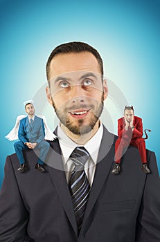 Businessman with angel and devil on his shoulders.