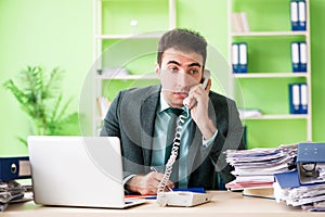 The businessman angry with excessive work sitting in the office