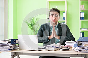 The businessman angry with excessive work sitting in the office