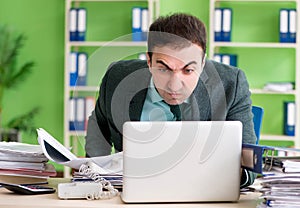 Businessman angry with excessive work sitting in the office