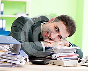 Businessman angry with excessive work sitting in the office