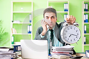 Businessman angry with excessive work sitting in the office in t