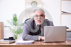 Businessman angry and furious at the workplace