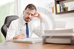 Businessman angry and overwhelmed with work