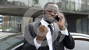 Businessman annoyed by unpleasant phone conversation, problems in business