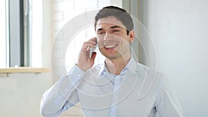 Businessman Answering Phone Call in Office