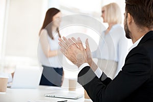 Businessman applauding at company meeting, congratulate colleague