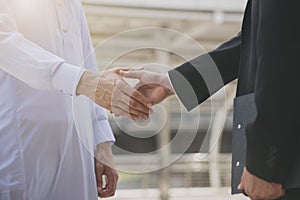 Businessman arabic making handshake agreement. concept partner