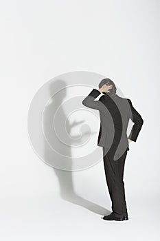 Businessman Arguing With Own Shadow