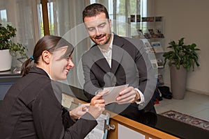 Businessman is arrived in hotel and is checking-in