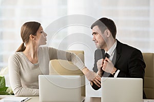 Businessman asking female colleague about favor
