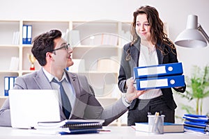 The businessman asking for paperwork from his assistant secretary