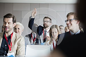 Businessman asking questions during seminar