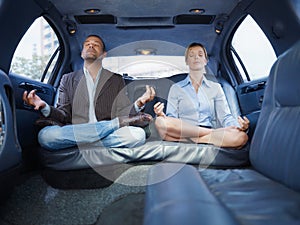 Businessman And Assistant Doing Yoga Sitting In Limousine Car