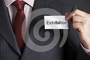 Businessman Attaching Exhibitor Badge To Jacket