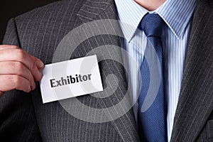 Businessman Attaching Exhibitor Badge To Jacket