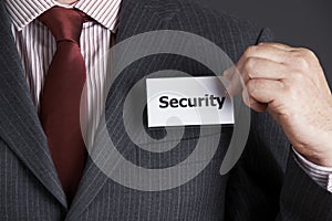 Businessman Attaching Security Badge To Jacket