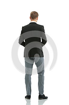 Businessman from the back - looking at something over a white ba