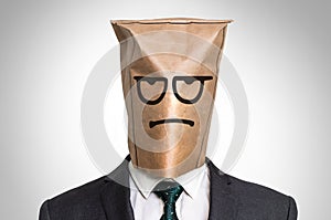 Businessman with a bag on the head - with sad face