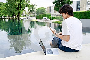 Businessman Balances Work and Leisure on Vacation by Poolside with Laptop