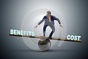 Businessman balancing between cost and benefit in business conce