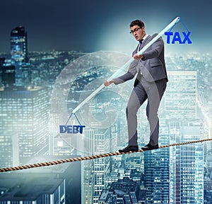 Businessman balancing between debt and tax